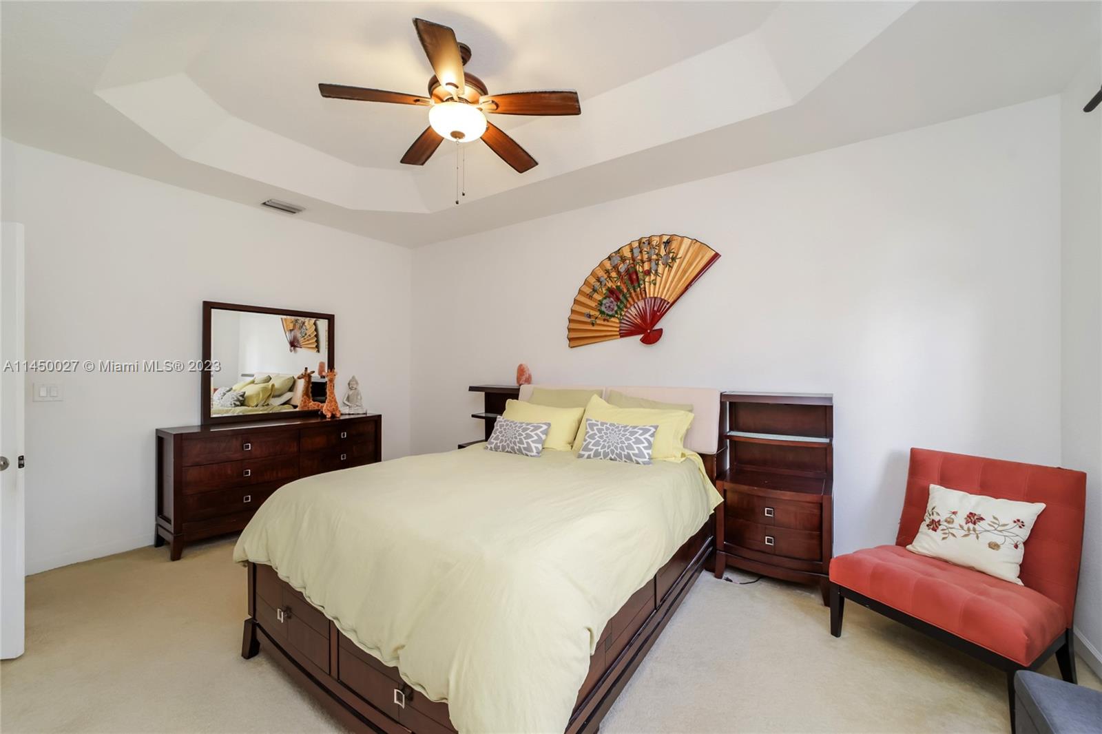12953 Southwest 132nd Terrace Miami, FL 33186 - Photo 22 of 36 a bedroom with a bed and a chandelier