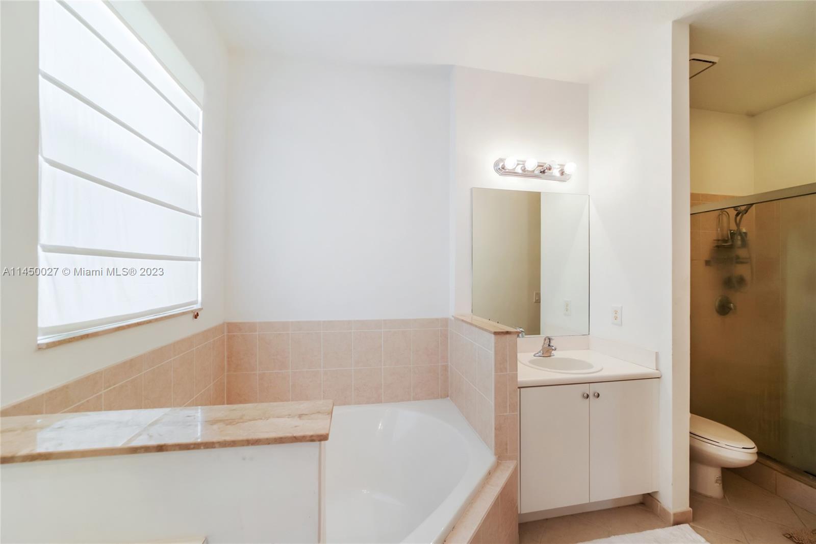 12953 Southwest 132nd Terrace Miami, FL 33186 - Photo 24 of 36 a bathroom with a tub and a sink
