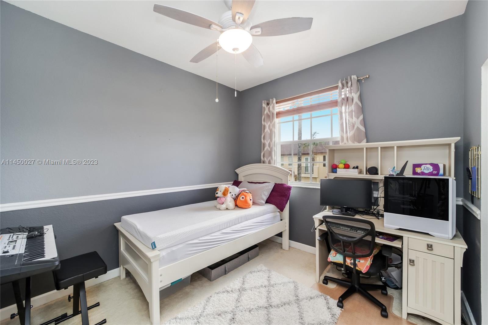 12953 Southwest 132nd Terrace Miami, FL 33186 - Photo 26 of 36 a bedroom with a bed and a window