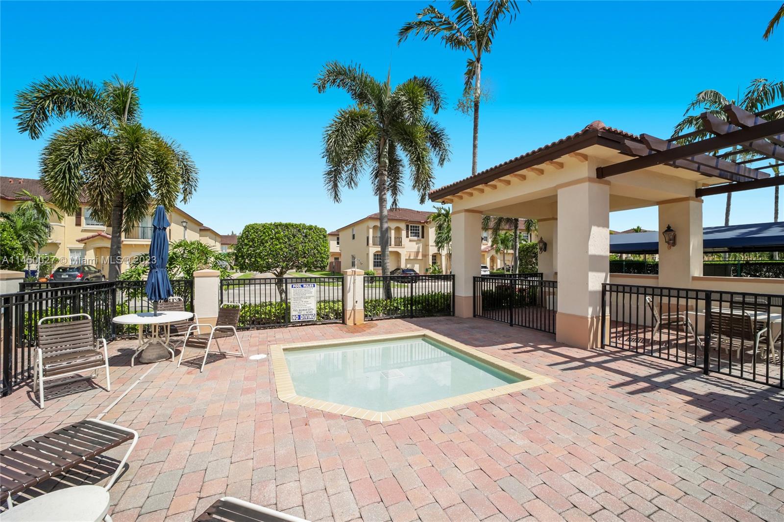 12953 Southwest 132nd Terrace Miami, FL 33186 - Photo 35 of 36 a view of a house with swimming pool and sitting area