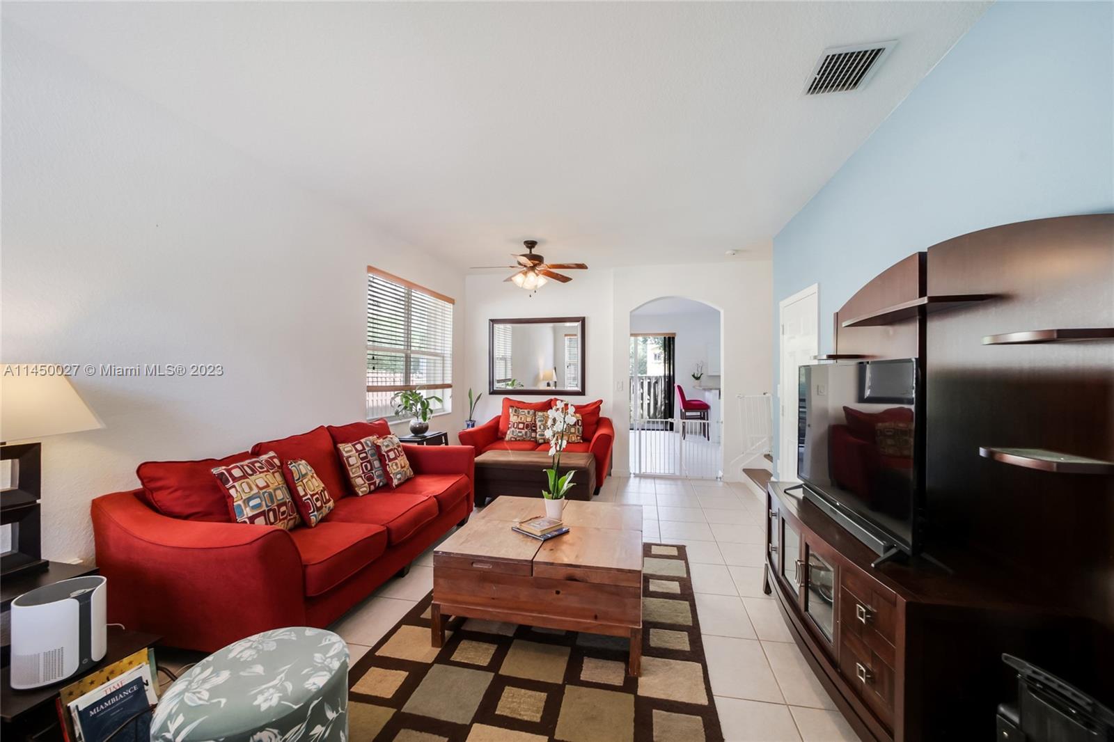 12953 Southwest 132nd Terrace Miami, FL 33186 - Photo 4 of 36 a living room with furniture and a flat screen tv