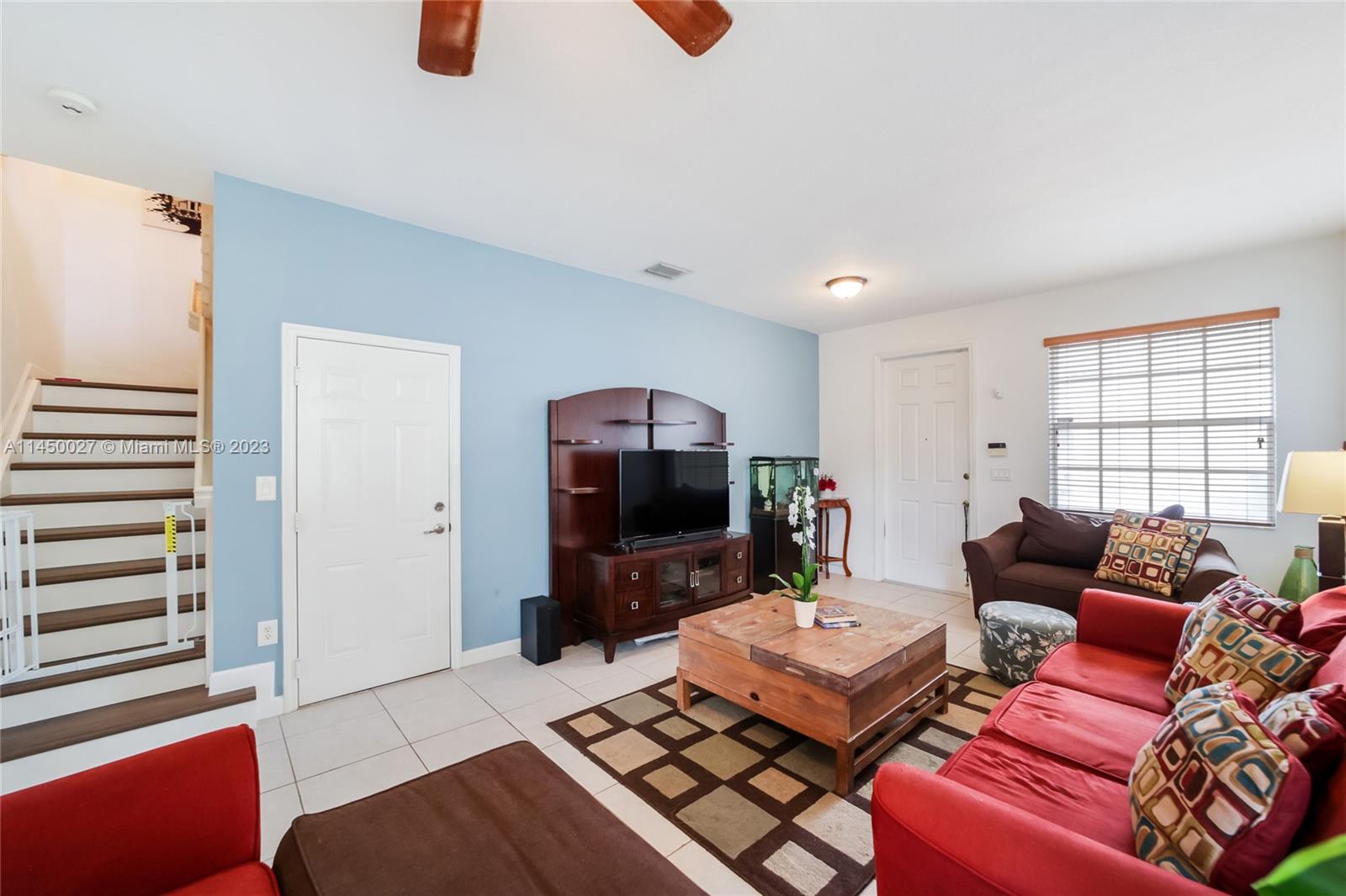 12953 Southwest 132nd Terrace Miami, FL 33186 - Photo 7 of 36 a living room with furniture and a flat screen tv