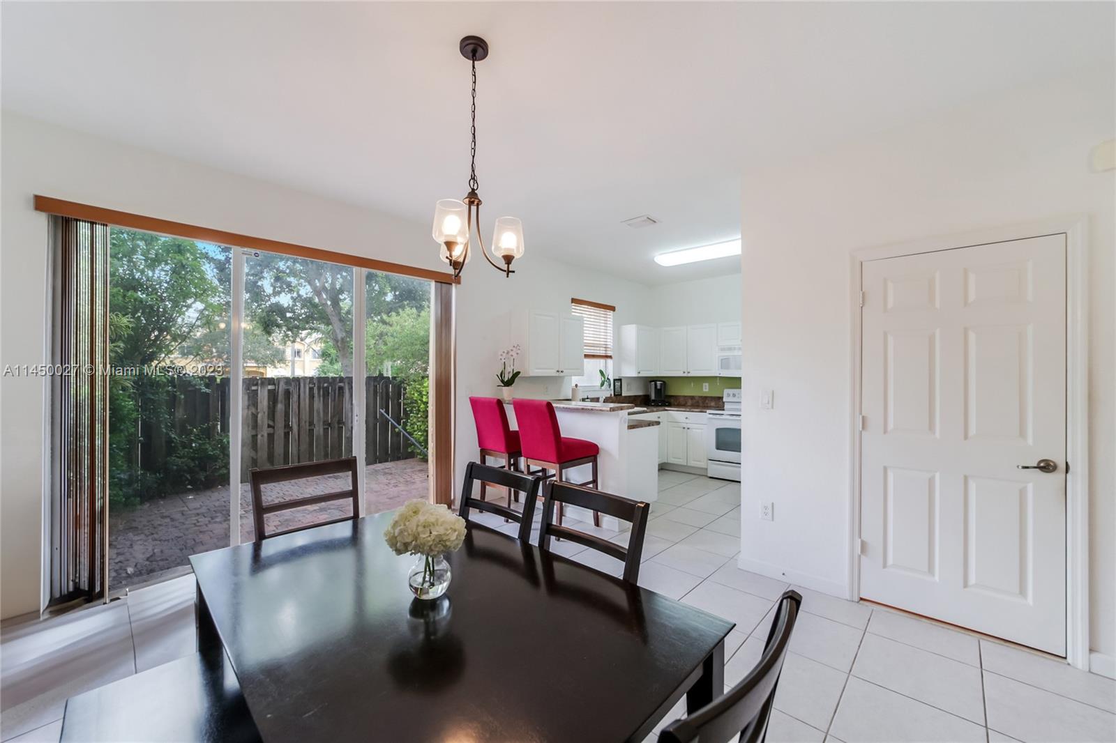 12953 Southwest 132nd Terrace Miami, FL 33186 - Photo 9 of 36 a living room with furniture and a floor to ceiling window