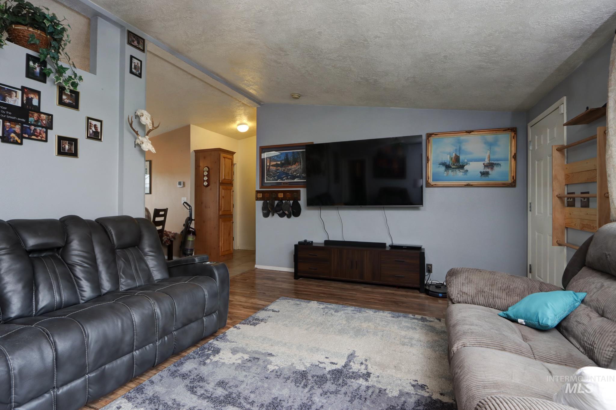 1583 Dustin Lane Vale, OR 97918 - Photo 11 of 39 Living room featuring lofted ceiling and wood finished floors