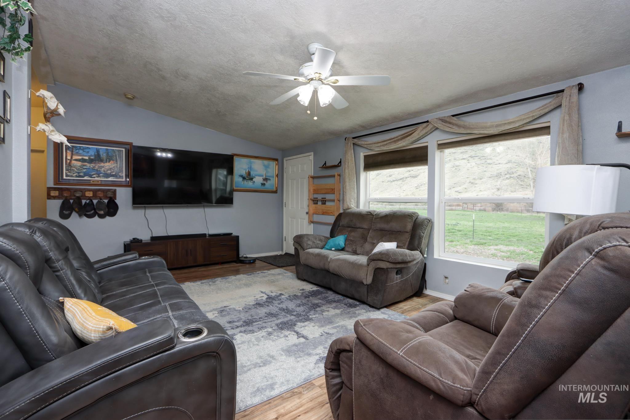 1583 Dustin Lane Vale, OR 97918 - Photo 12 of 39 Living area with wood finished floors, ceiling fan, and lofted ceiling