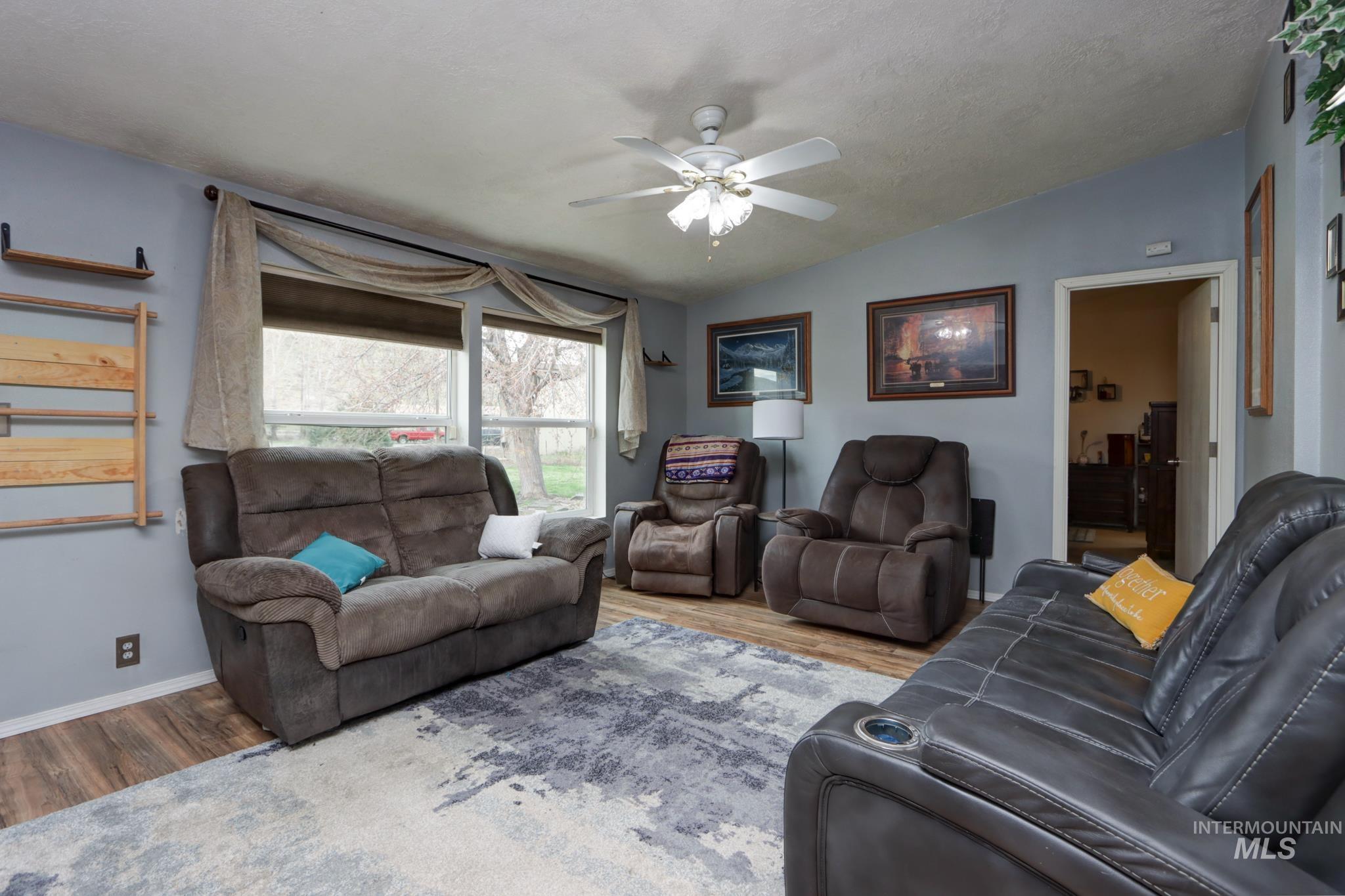 1583 Dustin Lane Vale, OR 97918 - Photo 13 of 39 Living area featuring vaulted ceiling, wood finished floors, and a ceiling fan