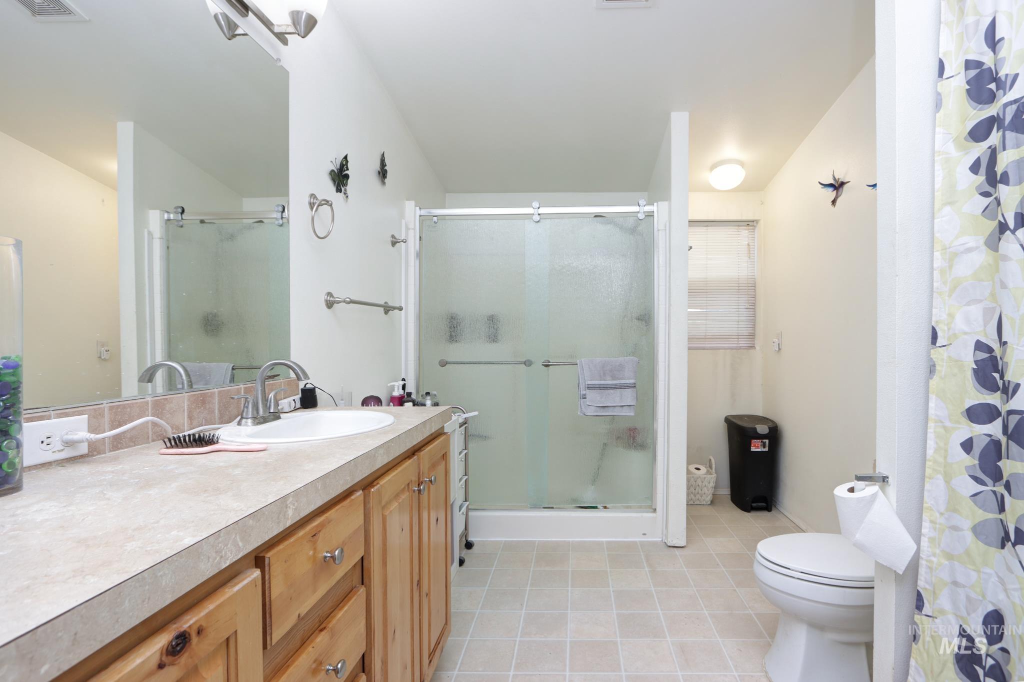 1583 Dustin Lane Vale, OR 97918 - Photo 17 of 39 Bathroom with a shower stall, vanity, and light tile patterned floors