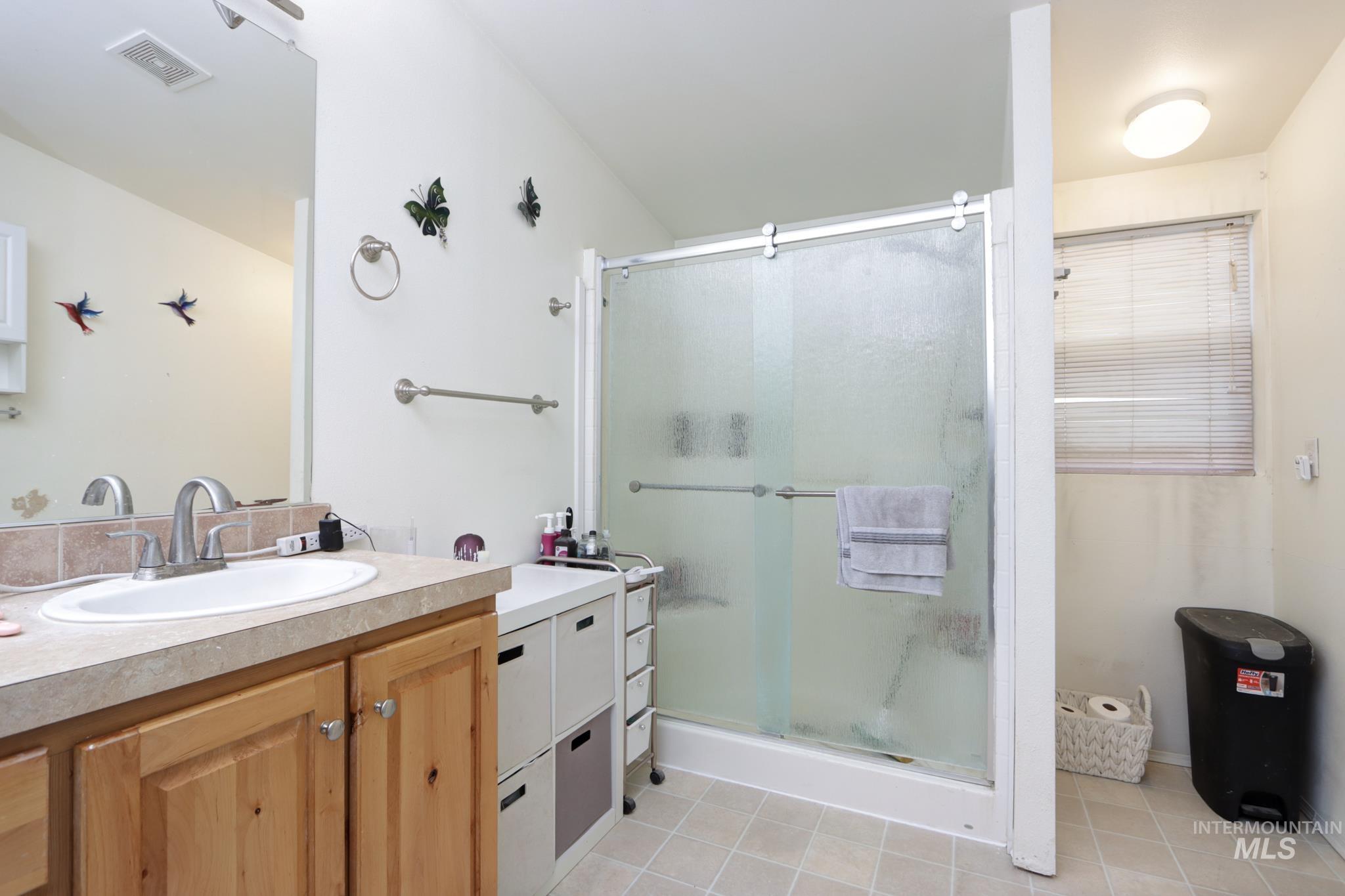 1583 Dustin Lane Vale, OR 97918 - Photo 19 of 39 Bathroom with vanity, a shower stall, and light tile patterned floors