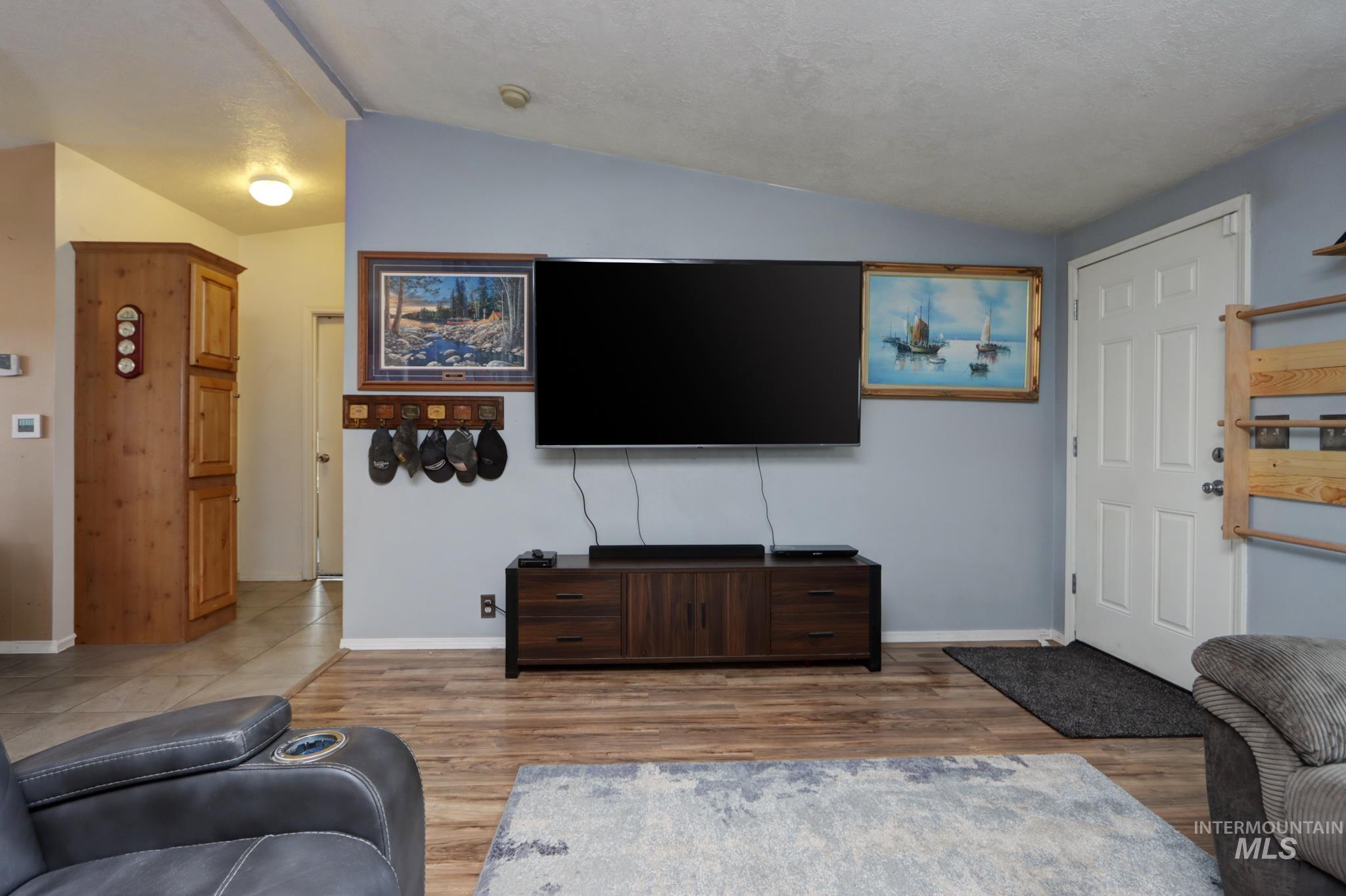 1583 Dustin Lane Vale, OR 97918 - Photo 10 of 39 Living area featuring lofted ceiling and light wood-style flooring