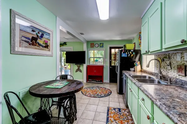 a kitchen with stainless steel appliances granite countertop a sink and a refrigerator