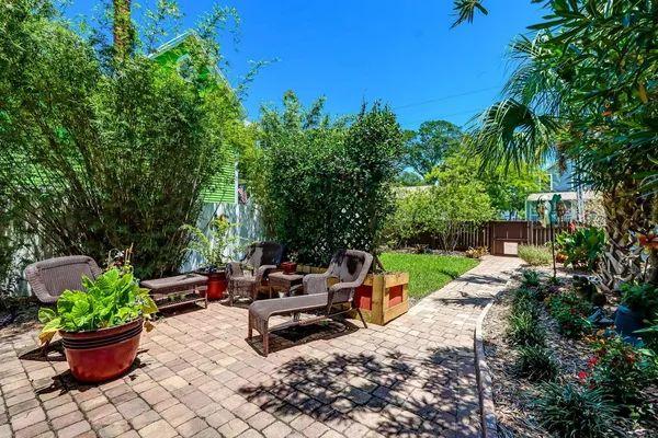 a view of a backyard with sitting area and garden