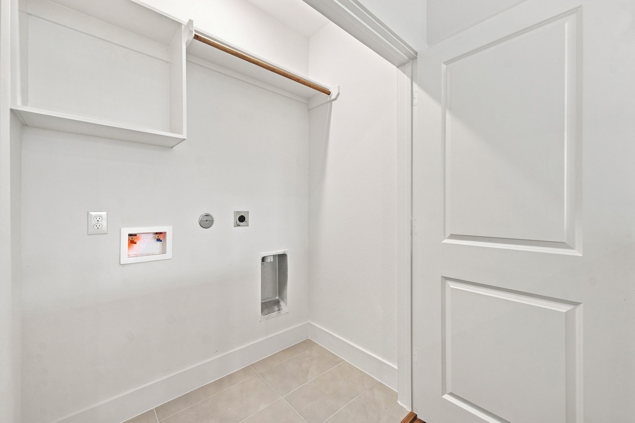 6057 Cebra Street Houston, TX 77091 - Photo 36 of 42 Dedicated laundry room with washer and dryer connections, built-in storage, and convenient hanging space. Photos are from a different property with a similar floor plan. Finishes, features, and orientation may vary.