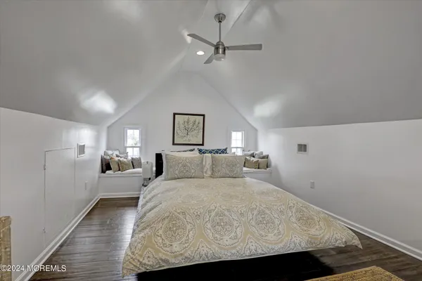 a bed room with a bed and a ceiling fan