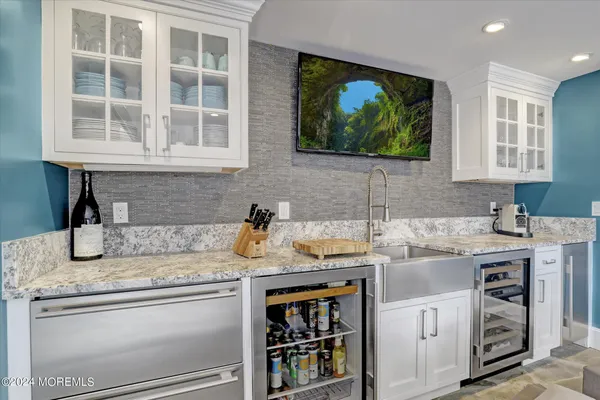 a living room with patio furniture and a flat screen tv