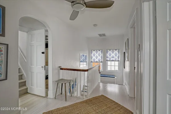 a view of a hallway with furniture and entryway