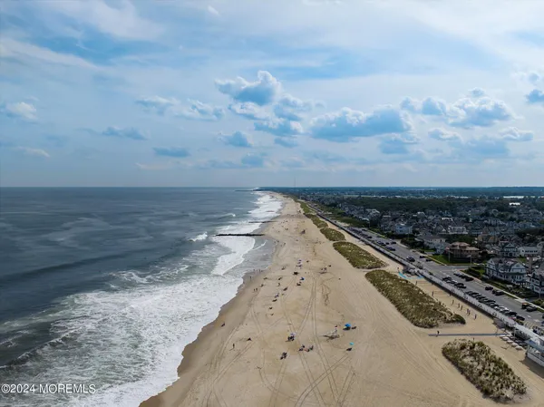 an aerial view of a city with lots of residential buildings in ocean