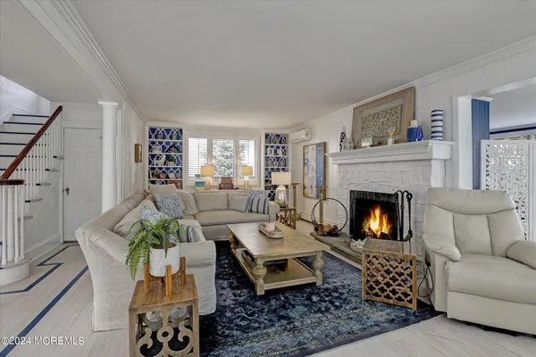 a kitchen with a sink a stove a refrigerator cabinets and a dining table