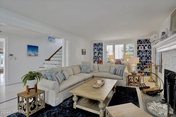 a kitchen with stainless steel appliances granite countertop a stove top oven a sink dishwasher and white cabinets with wooden floor
