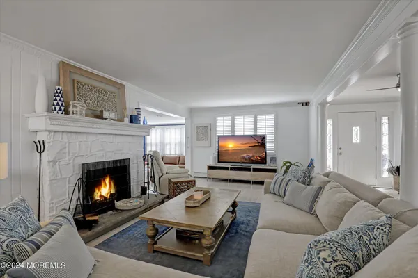 a large living room with stainless steel appliances granite countertop furniture and a rug