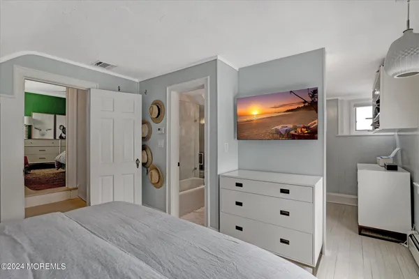 a bedroom with a bed and a television in it