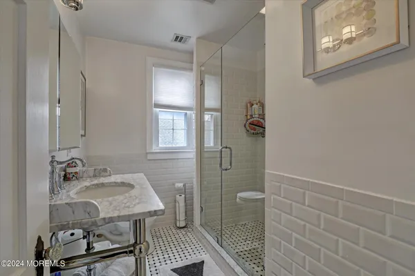 a bathroom with a sink and mirror
