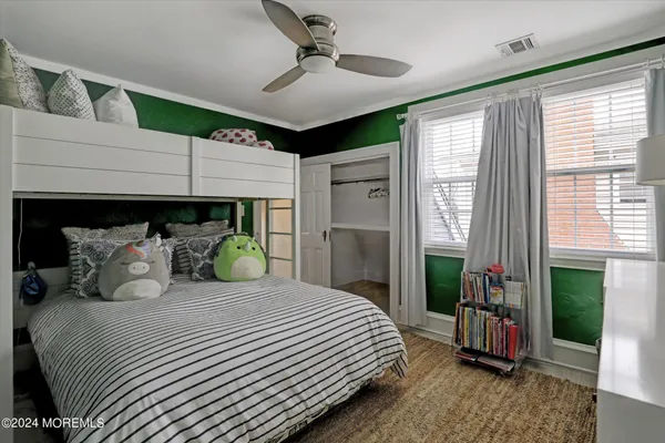 a bedroom with a large bed and a chandelier