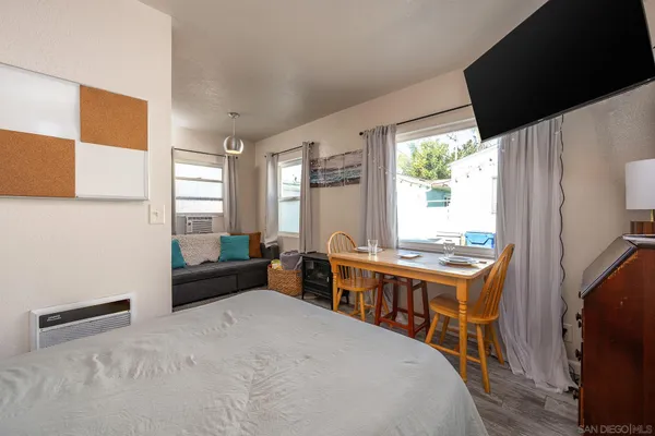 a bedroom with a bed and a large window