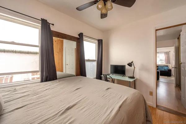 a bedroom with a large bed and a large window