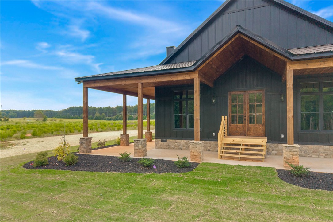 384 Jim Smith Road Pendleton, SC 29670 - Photo 4 of 48 Bold modern rustic design defines the exterior with a spacious covered porch and stone accents.