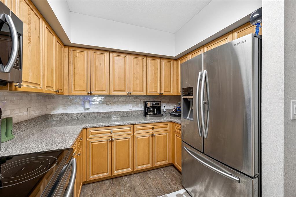 4516 Seagull Drive, Unit 519 New Port Richey, FL 34652 - Photo 11 of 54 a kitchen with a refrigerator a sink and cabinets