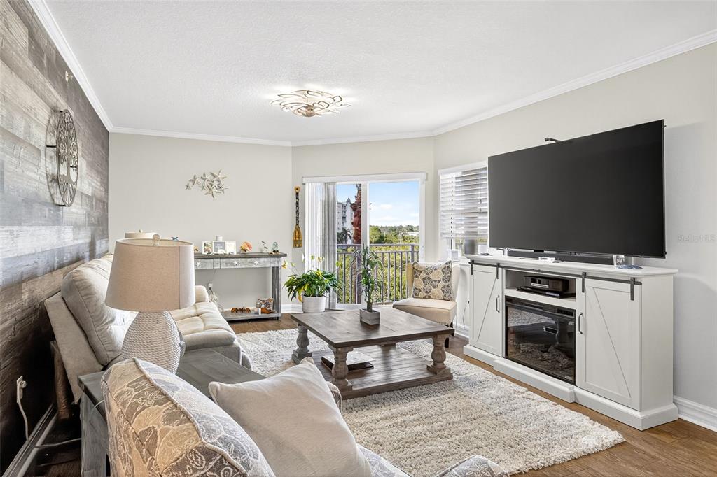 4516 Seagull Drive, Unit 519 New Port Richey, FL 34652 - Photo 14 of 54 a living room with furniture and a flat screen tv