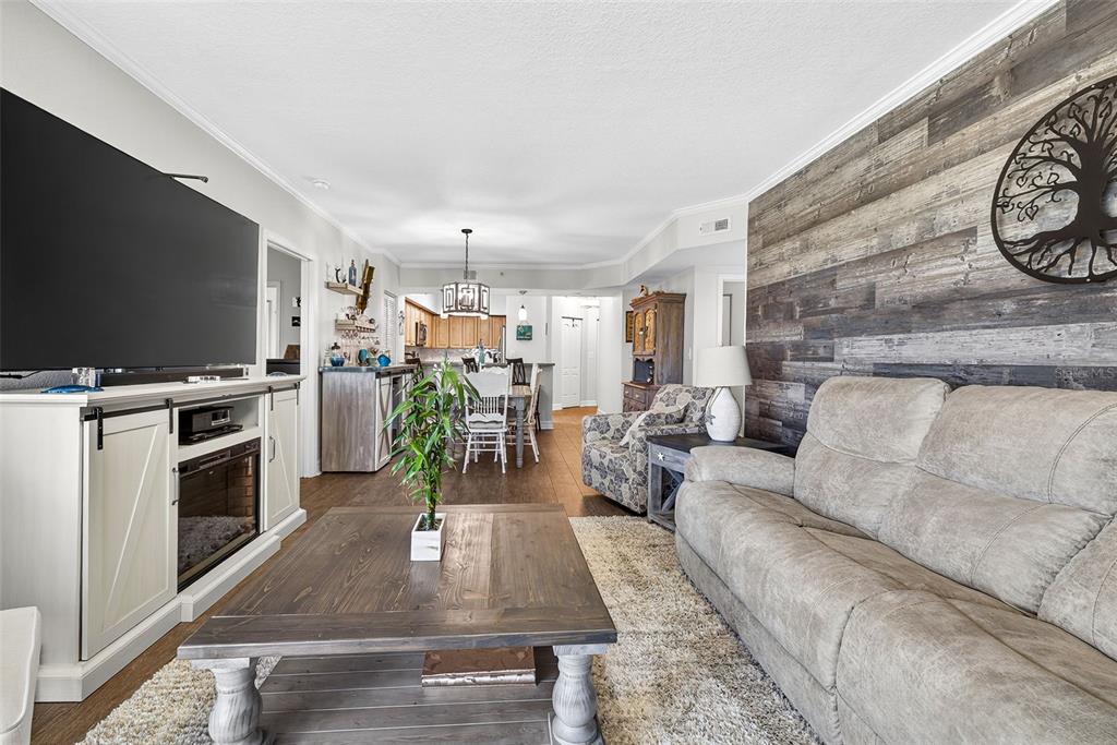 4516 Seagull Drive, Unit 519 New Port Richey, FL 34652 - Photo 16 of 54 a living room with furniture a flat screen tv and a fireplace