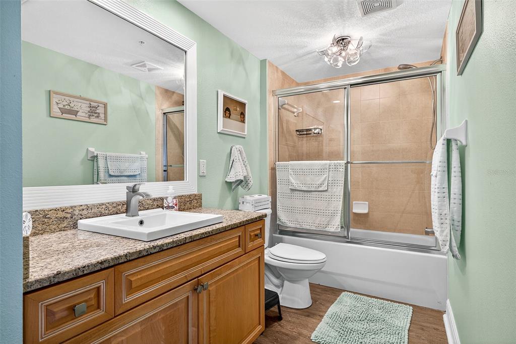 4516 Seagull Drive, Unit 519 New Port Richey, FL 34652 - Photo 18 of 54 a spacious bathroom with a granite countertop sink toilet and shower