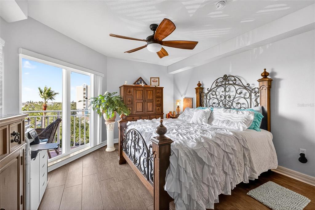 4516 Seagull Drive, Unit 519 New Port Richey, FL 34652 - Photo 20 of 54 a bedroom with double bed windows and a chandelier