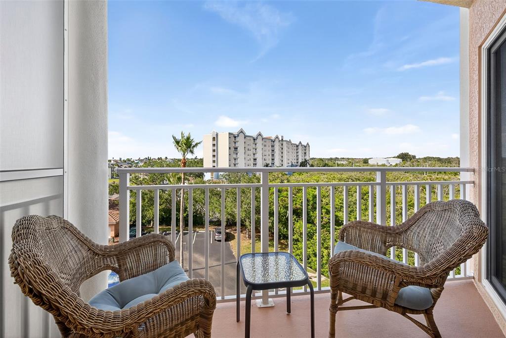 4516 Seagull Drive, Unit 519 New Port Richey, FL 34652 - Photo 21 of 54 a balcony with furniture and a floor to ceiling window