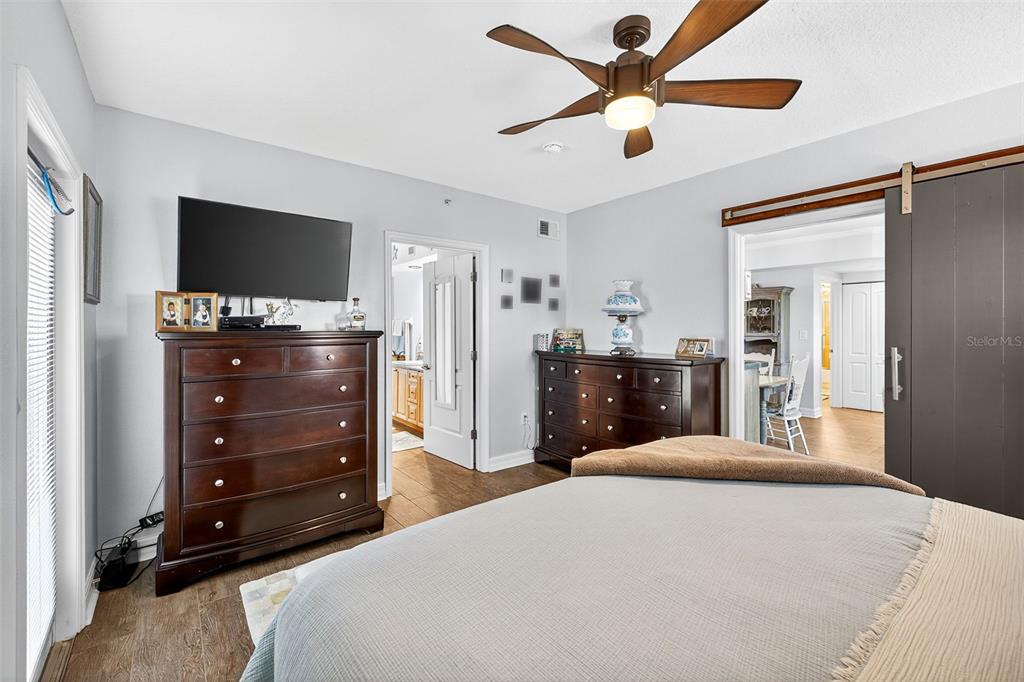 4516 Seagull Drive, Unit 519 New Port Richey, FL 34652 - Photo 24 of 54 a bedroom with a bed and a flat screen tv