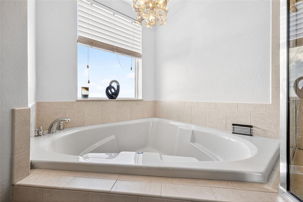 4516 Seagull Drive, Unit 519 New Port Richey, FL 34652 - Photo 27 of 54 a white bath tub sitting in a bathroom