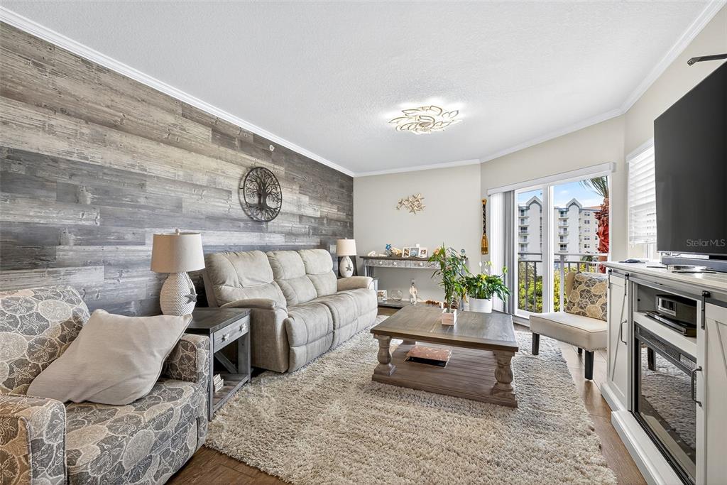 4516 Seagull Drive, Unit 519 New Port Richey, FL 34652 - Photo 4 of 54 a living room with furniture and a flat screen tv