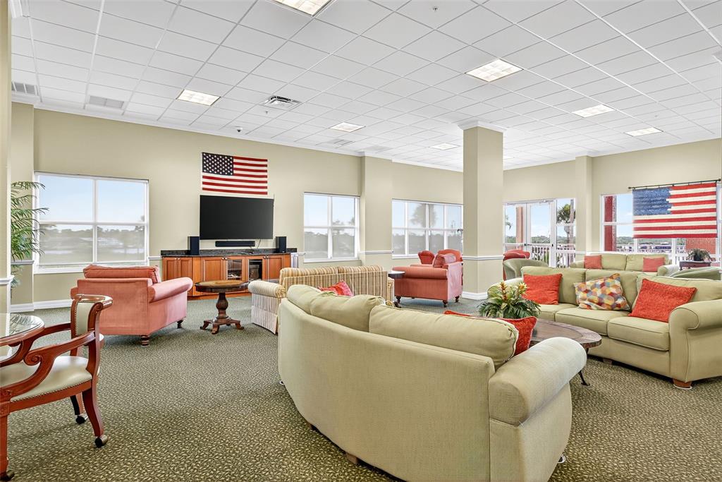4516 Seagull Drive, Unit 519 New Port Richey, FL 34652 - Photo 42 of 54 a living room with furniture kitchen view and a flat screen tv