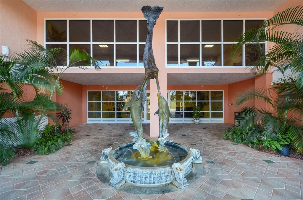 4516 Seagull Drive, Unit 519 New Port Richey, FL 34652 - Photo 49 of 54 a front view of a house with a yard and fountain