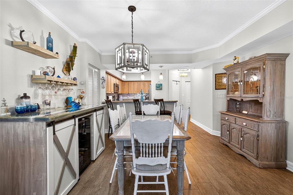 4516 Seagull Drive, Unit 519 New Port Richey, FL 34652 - Photo 5 of 54 a view of a dining room with furniture a chandelier and wooden floor