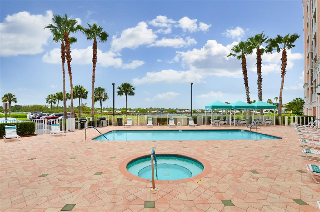 4516 Seagull Drive, Unit 519 New Port Richey, FL 34652 - Photo 51 of 54 a view of a swimming pool with a table and chairs