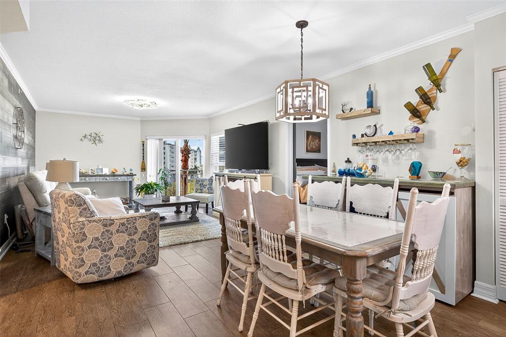 4516 Seagull Drive, Unit 519 New Port Richey, FL 34652 - Photo 7 of 54 a dining room with furniture a chandelier and wooden floor