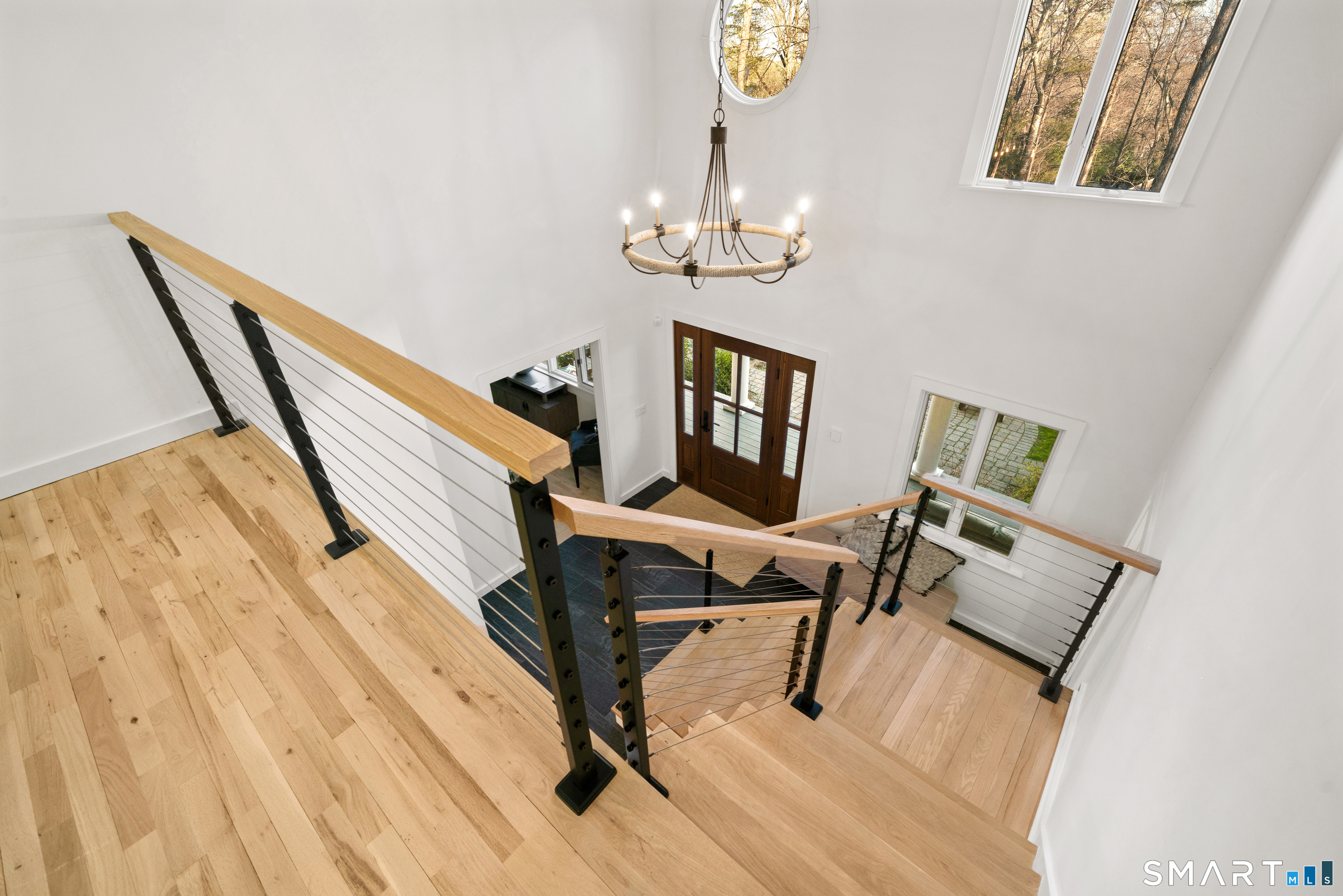 23 Norton Road Easton, CT 06612 - Photo 20 of 40 A light filled two story foyer with a modern cable rail staircase rising to the second level, creating a striking sense of height and openness