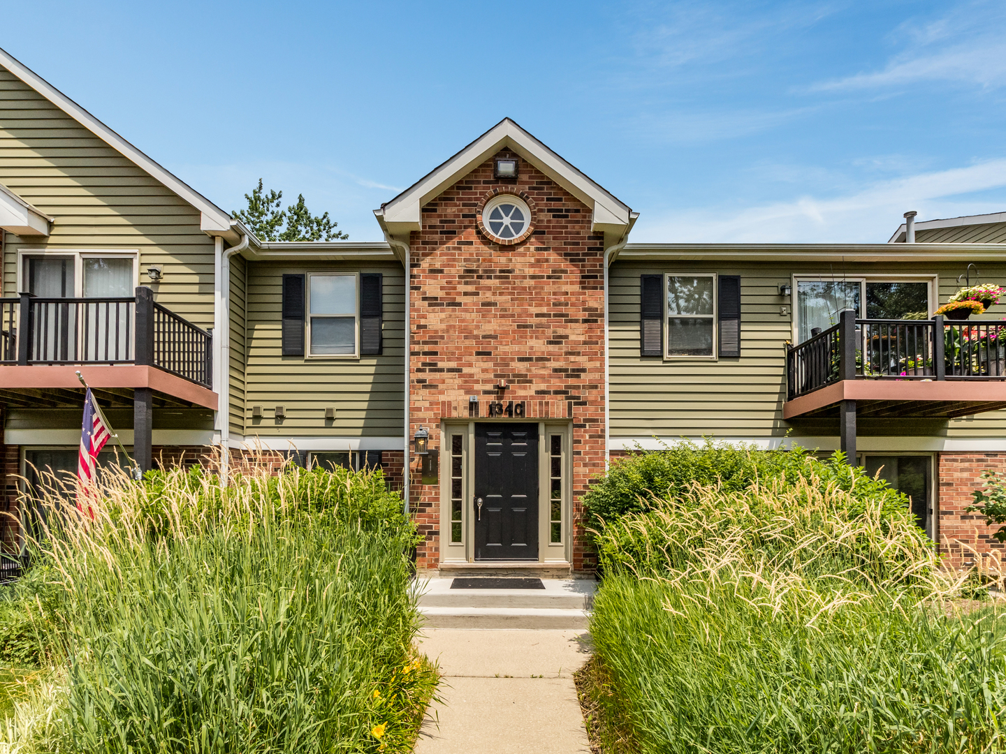 1340 McDowell Road, Unit 202 Naperville, IL 60563 - Photo 1 of 24 a front view of a house with a yard