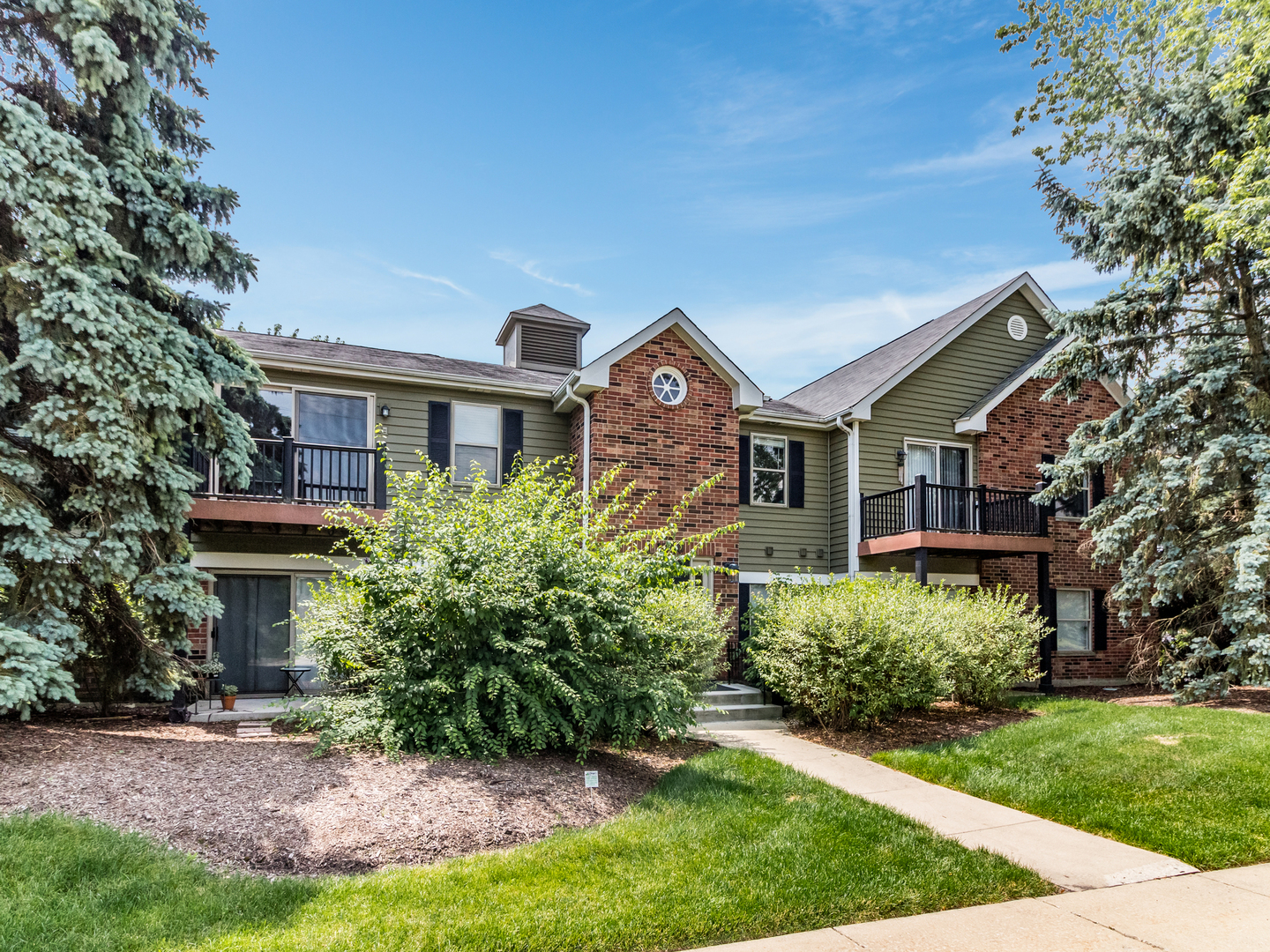 1340 McDowell Road, Unit 202 Naperville, IL 60563 - Photo 3 of 24 a front view of a house with a yard