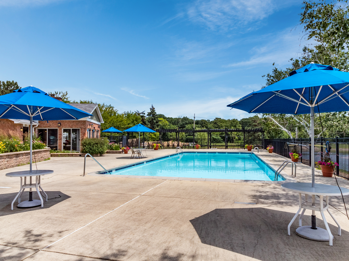 1340 McDowell Road, Unit 202 Naperville, IL 60563 - Photo 23 of 24 a view of pool with lawn chairs under an umbrella