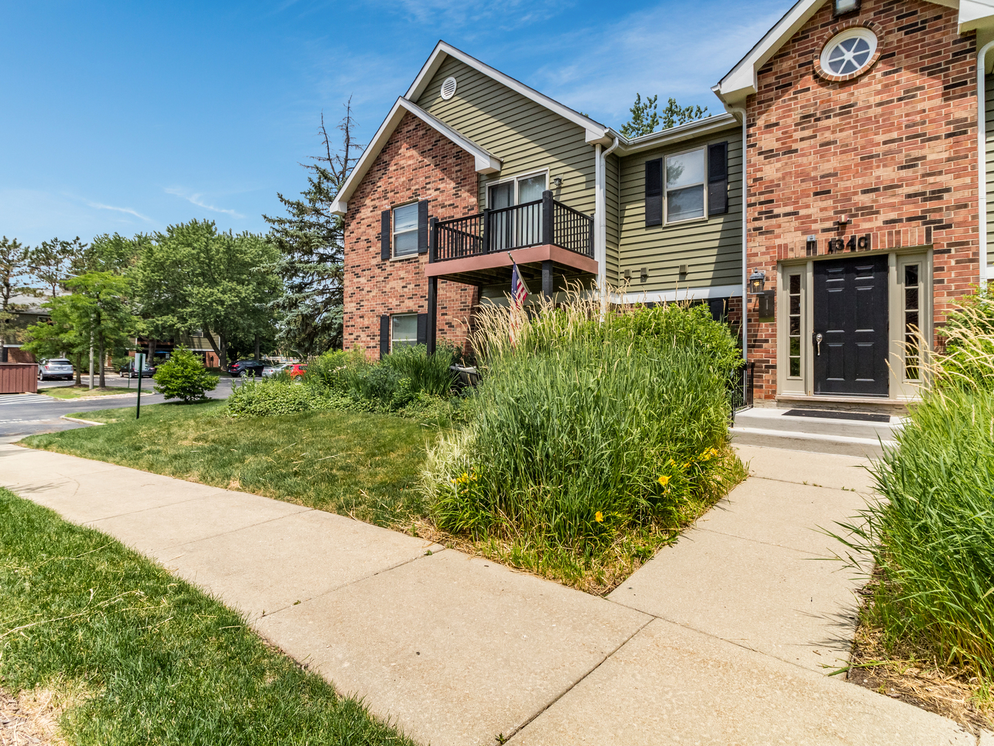 1340 McDowell Road, Unit 202 Naperville, IL 60563 - Photo 4 of 24 a front view of a house with a yard
