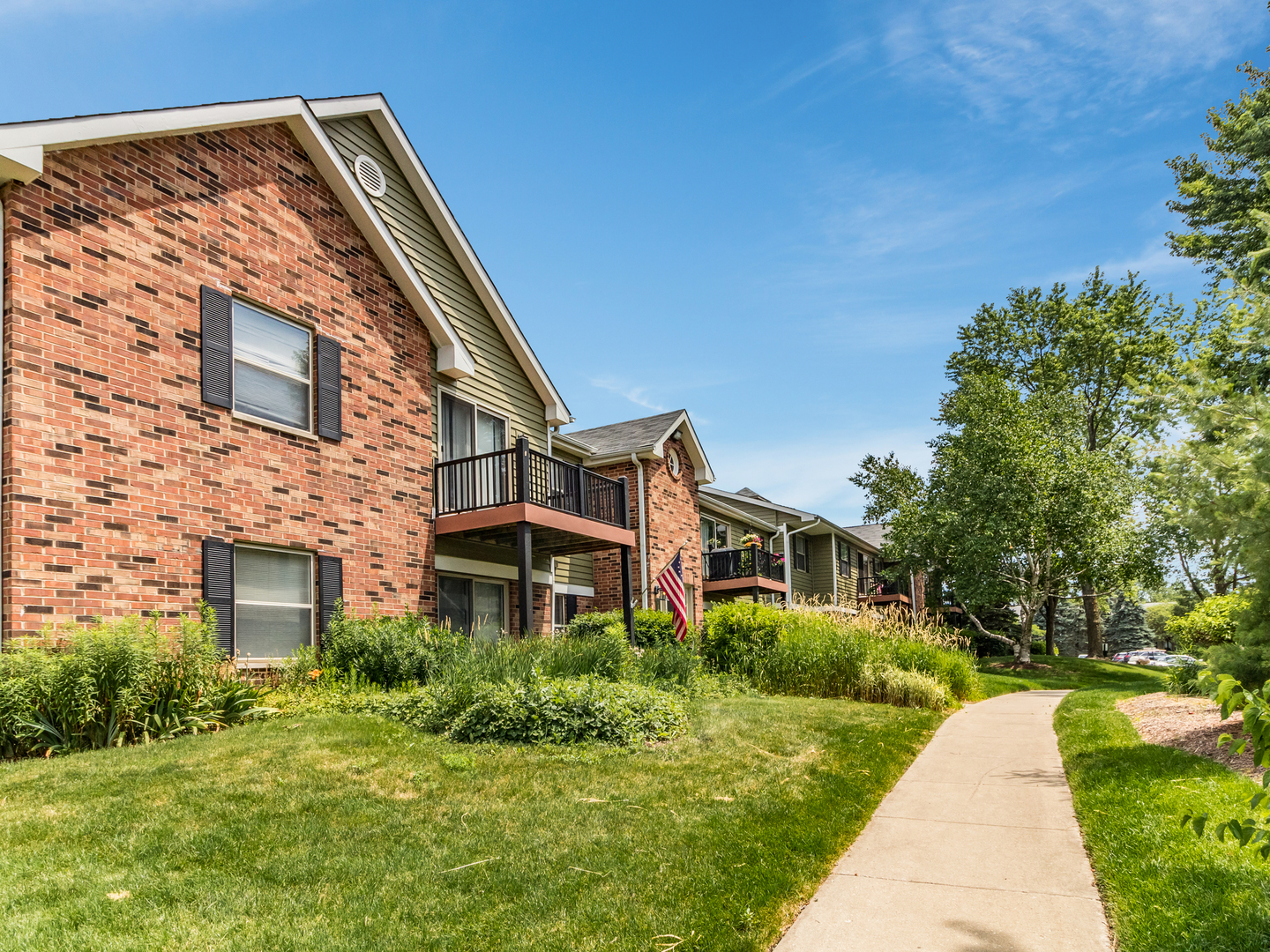 1340 McDowell Road, Unit 202 Naperville, IL 60563 - Photo 5 of 24 a front view of a house with a yard