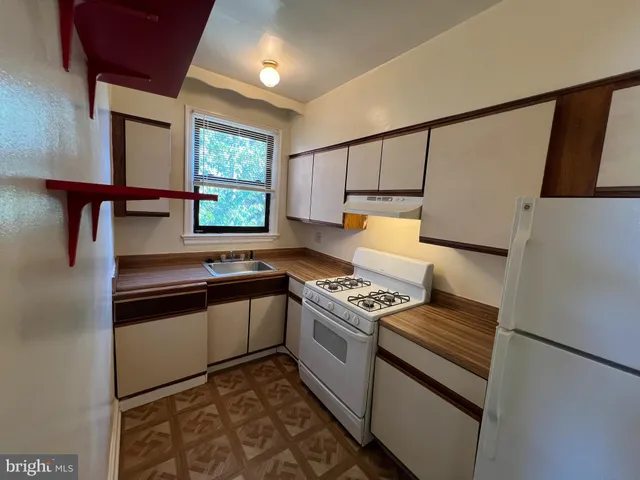 a kitchen with stainless steel appliances granite countertop a stove and a refrigerator